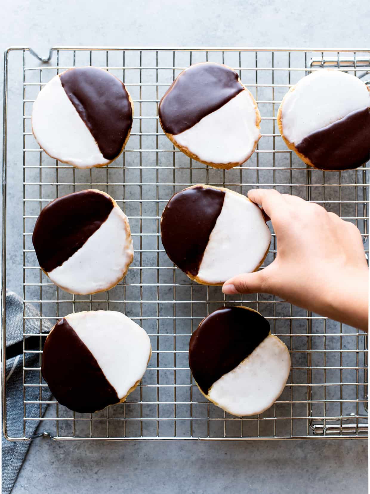Black and White Cookies - a New York deli classic. Frosted with vanilla and chocolate icing, these cake-like cookies deliver the best of both worlds.