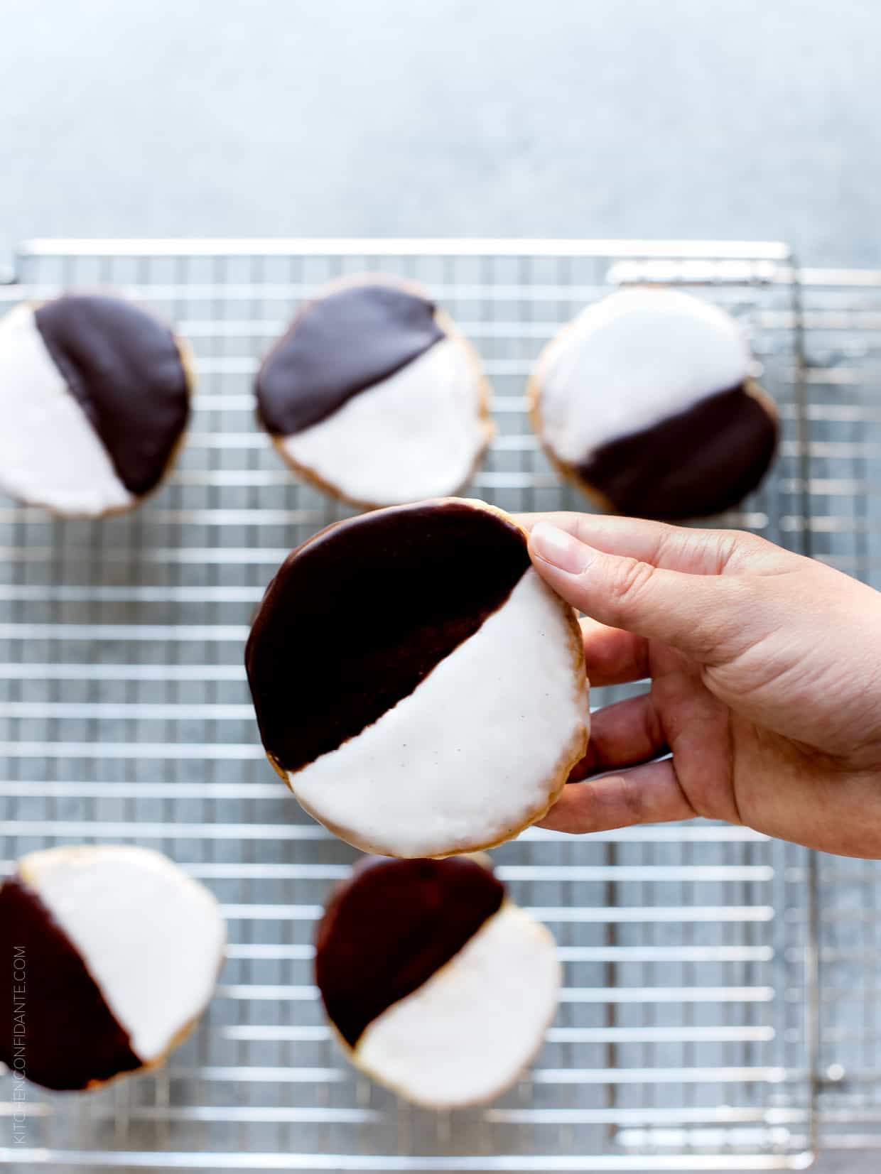 Black and White Cookies - a New York deli classic. Frosted with vanilla and chocolate icing, these cake-like cookies deliver the best of both worlds.