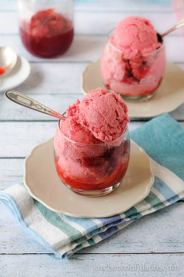 Glasses filled with strawberry sauce and homemade strawberry frozen yogurt.