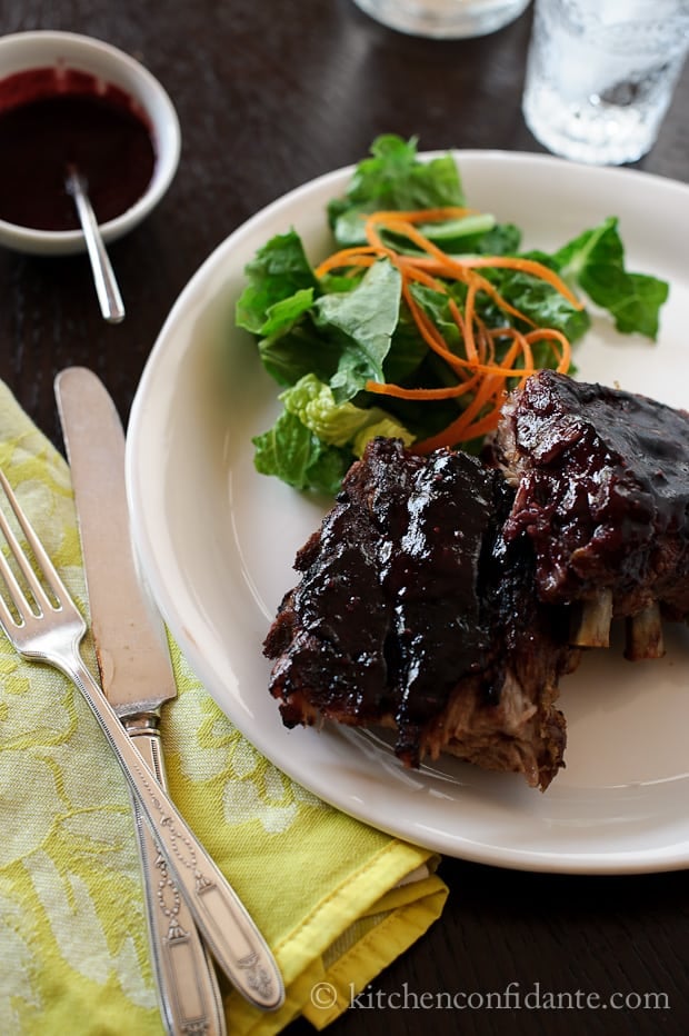 A plate of salad and blackberry ribs - barbecued to perfection and smothered in a sticky blackberry glaze.