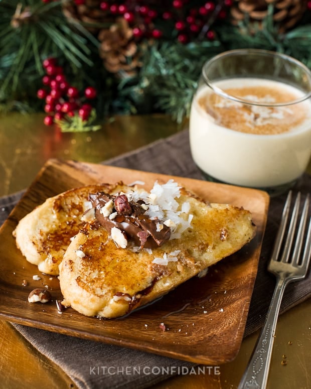 Coconut Hazelnut Eggnog French Toast ready to eat, topped with coconut, syrup, and pecan pieces.