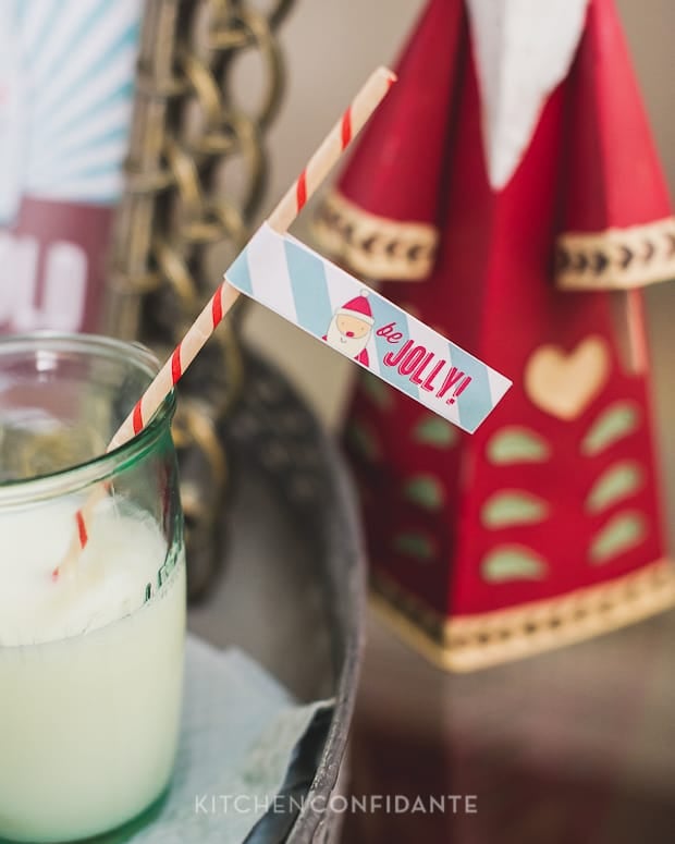 A little party flag for our plate of santa treats that says "be jolly" attached to a straw that sits in a cup of milk. 