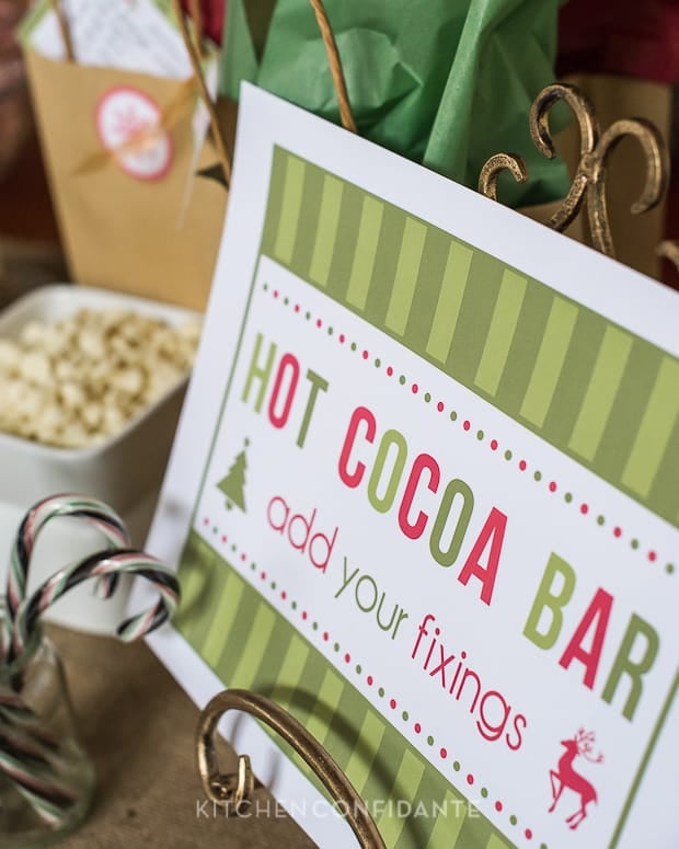 A green striped sign that says "HOT COCOA BAR add your fixings".