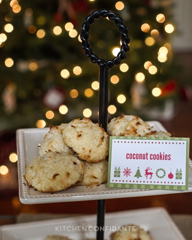 A decorative tiered stand full of cokies. A red and green sign says "coconut cookies".