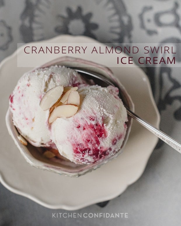 A bowl of homemade ice cream topped with slivered almonds with the words, "Cranberry Almond Swirl Ice Cream". 