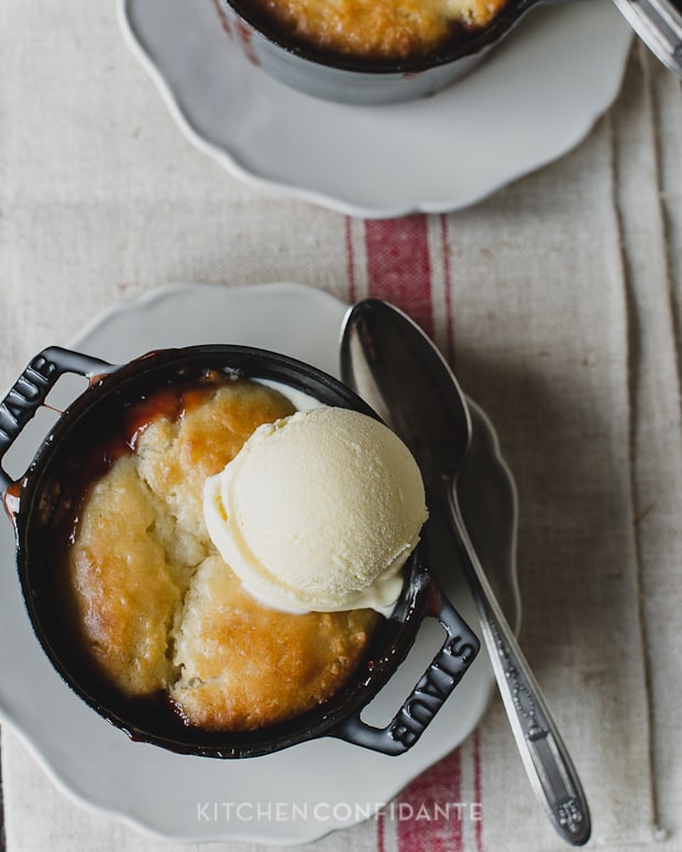 Cranberry Rhubarb Cobbler baked in a mini Dutch oven and topped with vanilla ice cream.