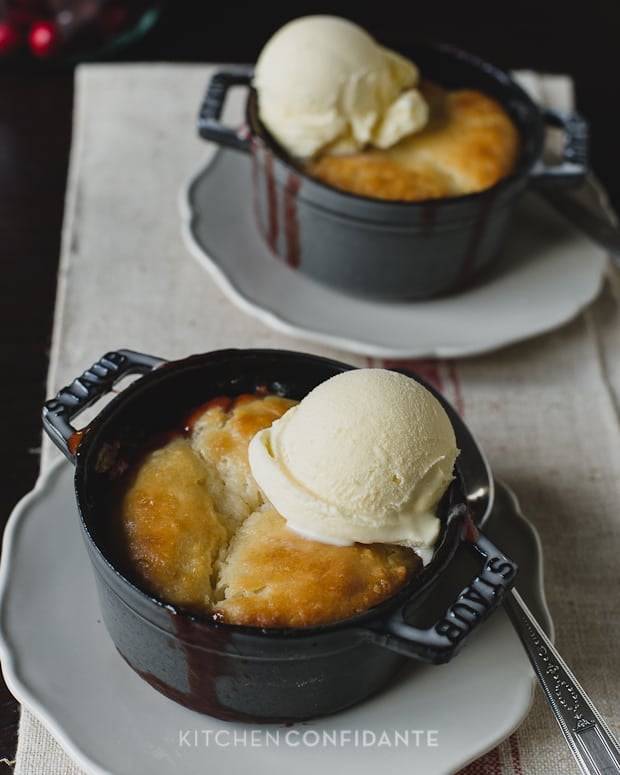 Cranberry Rhubarb Cobbler baked in mini Dutch ovens and topped with vanilla ice cream.