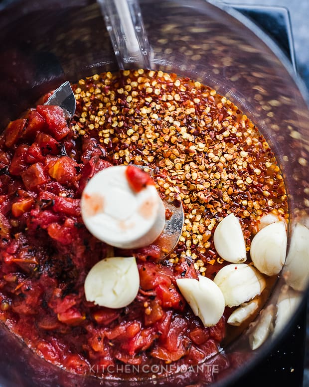 Fire roasted tomatoes, garlic cloves, and red chili flakes in a food processor. 