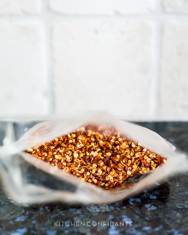 Red pepper flakes in a bag on a countertop.