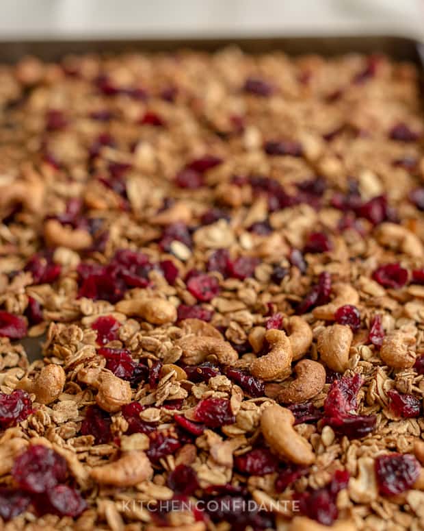 Trail Mix Granola with Cashews, Almonds and Cranberries on a baking sheet.