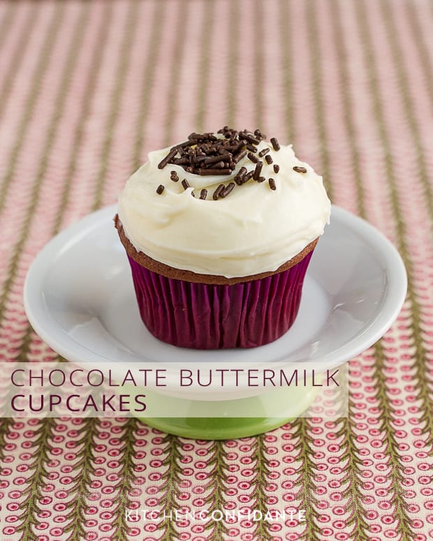 A chocolate cupcake with cream cheese frosting and chocolate sprinkles with the words, "Chocolate Buttermilk Cupcakes." 