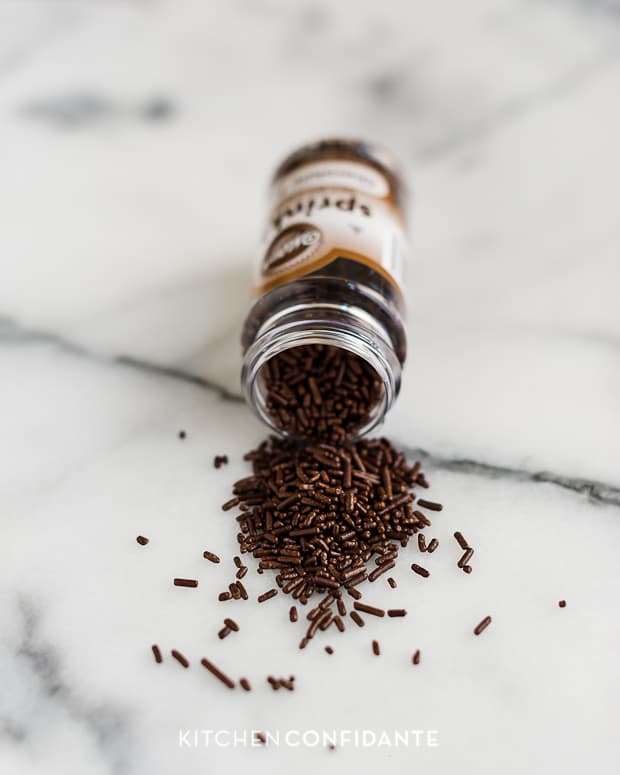 Chocolate sprinkles pouring out of the jar.