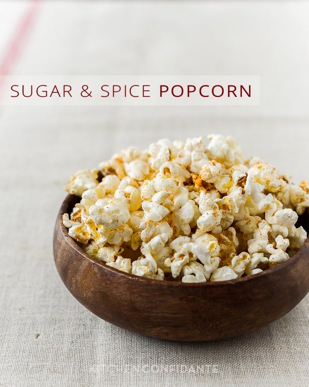 A bowl of spiced popcorn with the words, "Sugar and Spice Popcorn". 