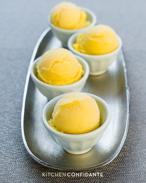 Mango Ginger Sorbet in white bowls arranged on a tray.