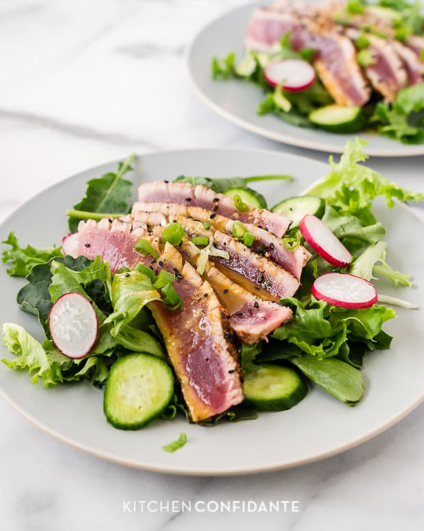 Slices of seared ahi tuna on salad greens with cucumbers, radishes, and wasabi-soy dressing.