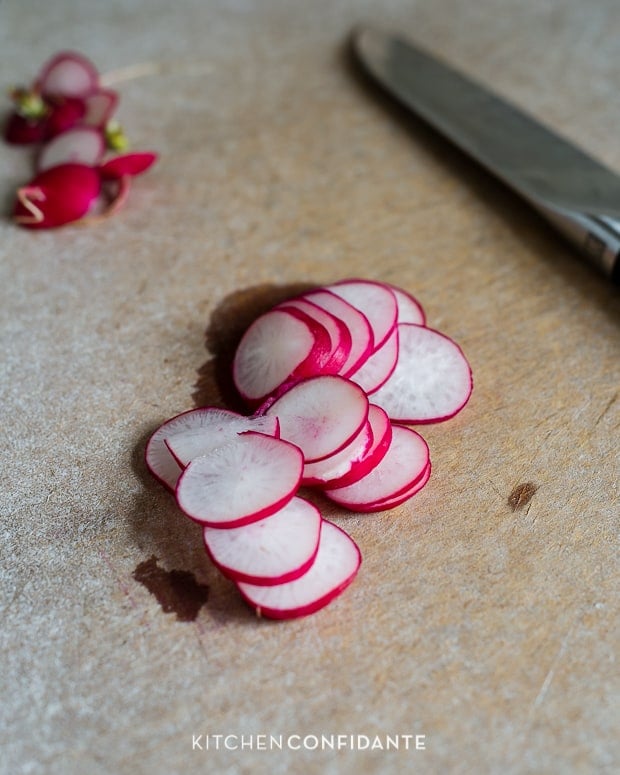 Sliced Radishes on a cutting board.