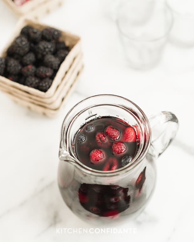 Looking down into a pitcher filled with Berry Sangria.