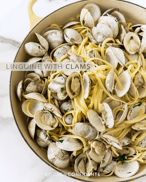 Open clams in a large pot of linguine pasta.