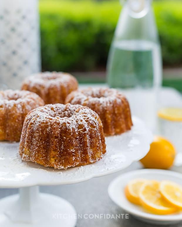 Individual Bundt Cakes served on a white cake stand.