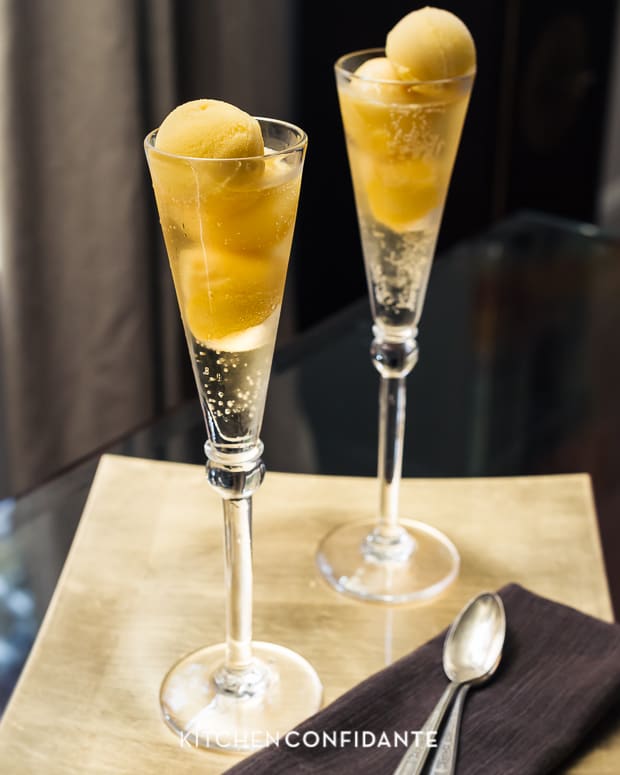 Scoops of mango sorbet topped with sparkling wine and served in champagne flutes.