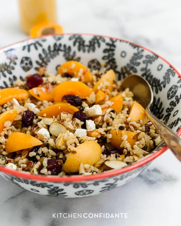 Wild Rice Salad with Apricots & Almonds and Apricot Dressing served in a bowl.