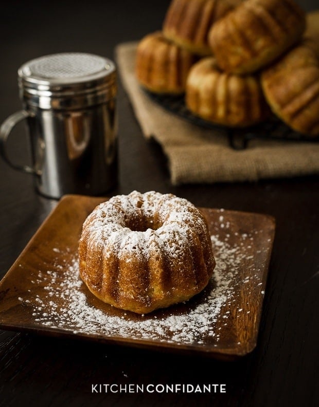 A Banana Pineapple Mini Bundt Cake sprinkled with a dusting of powdered sugar.