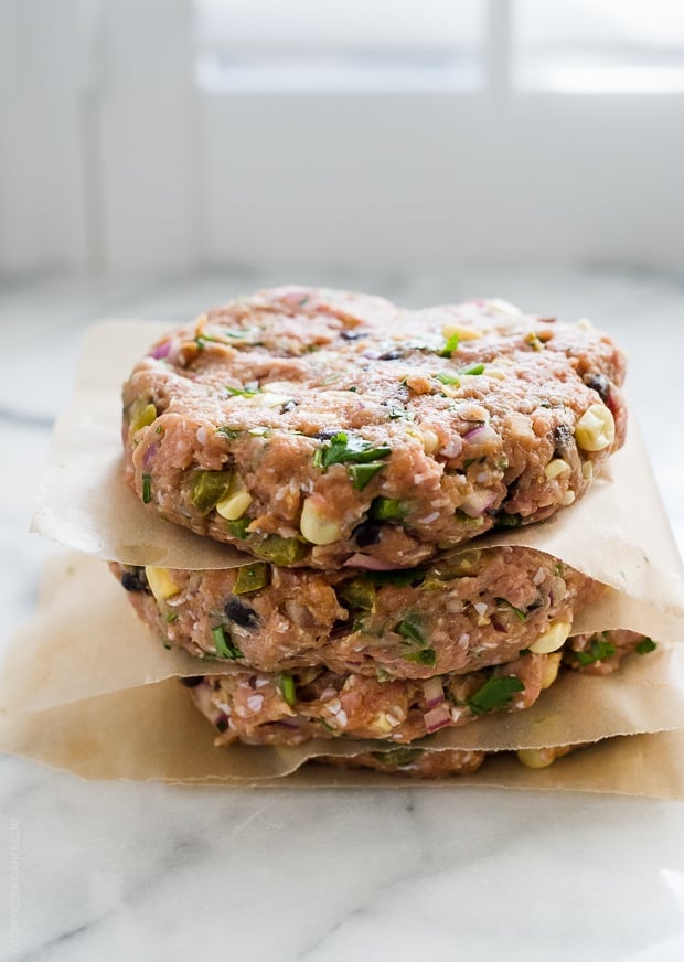 Homemade turkey burgers in a stack ready to grill.