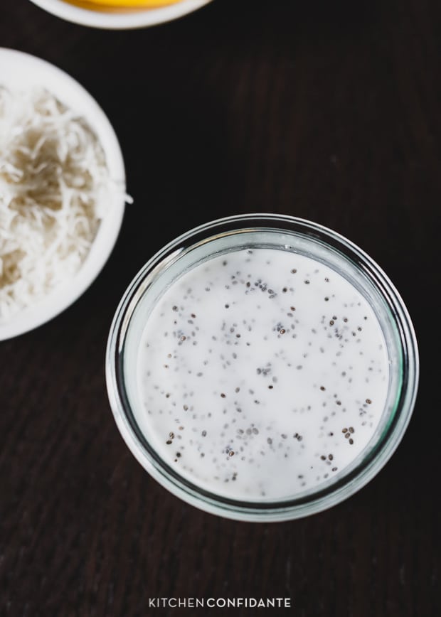 Chia seeds, coconut milk, and sugar in a glass.