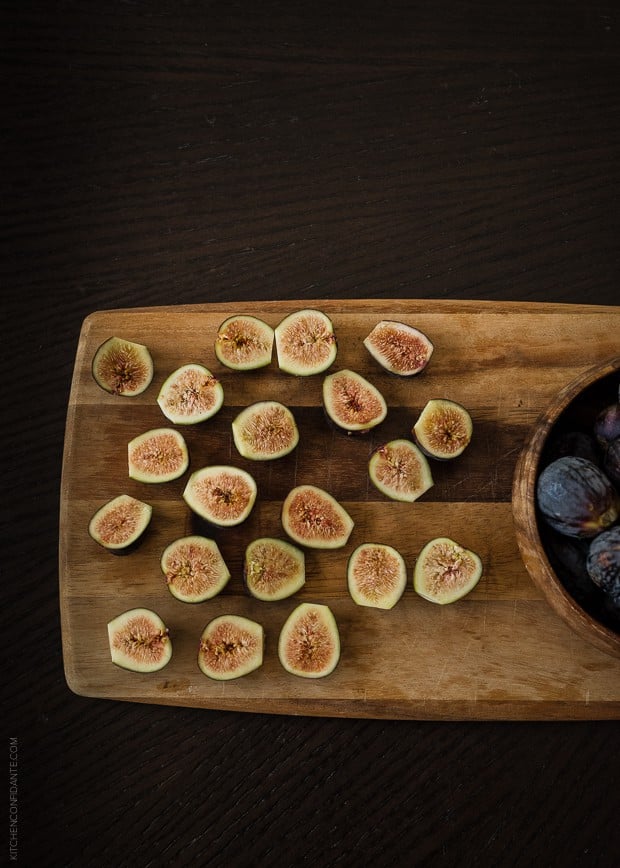 Fresh fruit sliced open on a wooden board.