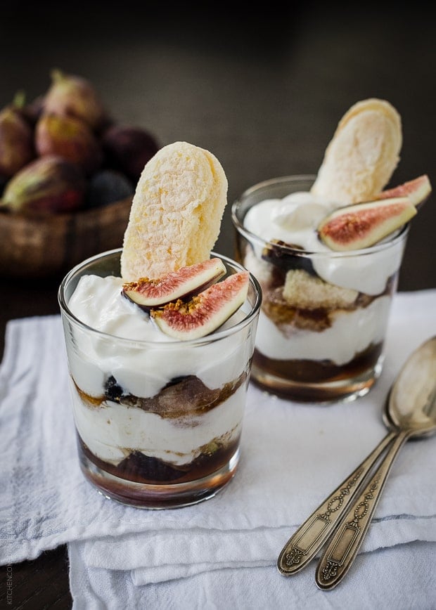 Honeyed Fig Trifle with Goat Cheese Mascarpone Yogurt Cream layered in a glass and topped with sliced figs and ladyfingers.