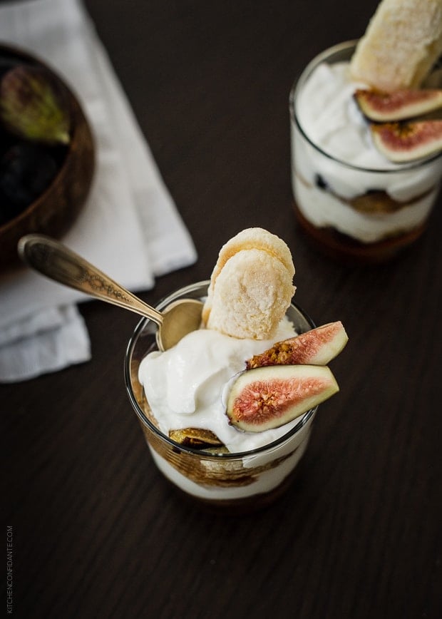 A Honeyed Fig Trifle with Goat Cheese Mascarpone Yogurt Cream served in a glass.