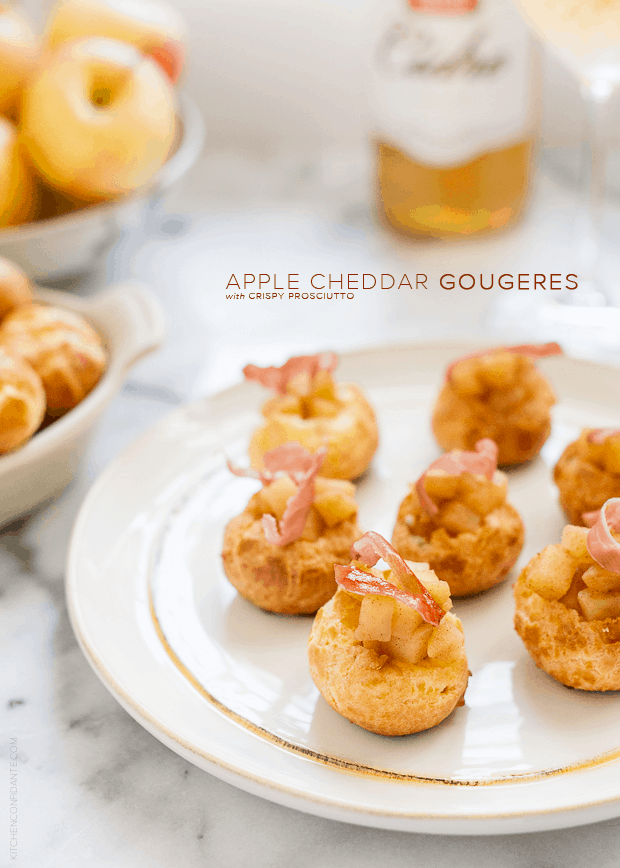 Apple Cheddar Gougères with Crispy Prosciutto arranged on a white serving plate.