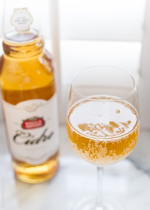 A glass filled with Stella Artois Cidre and the bottle in the background.