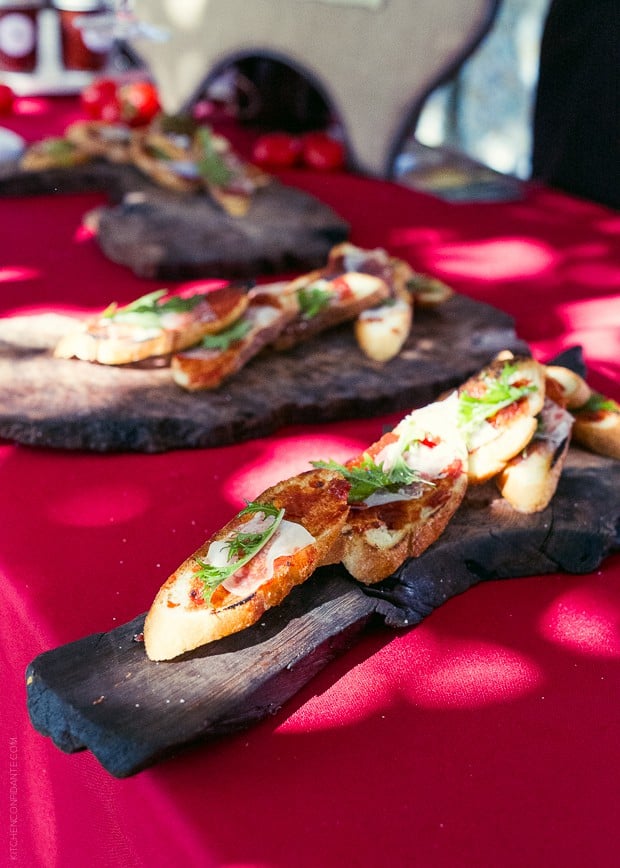 Wooden boards stacked with Heirloom Tomato Crostini with Lardo from Backyard / Fire Roasted Tomato Jam Crostini