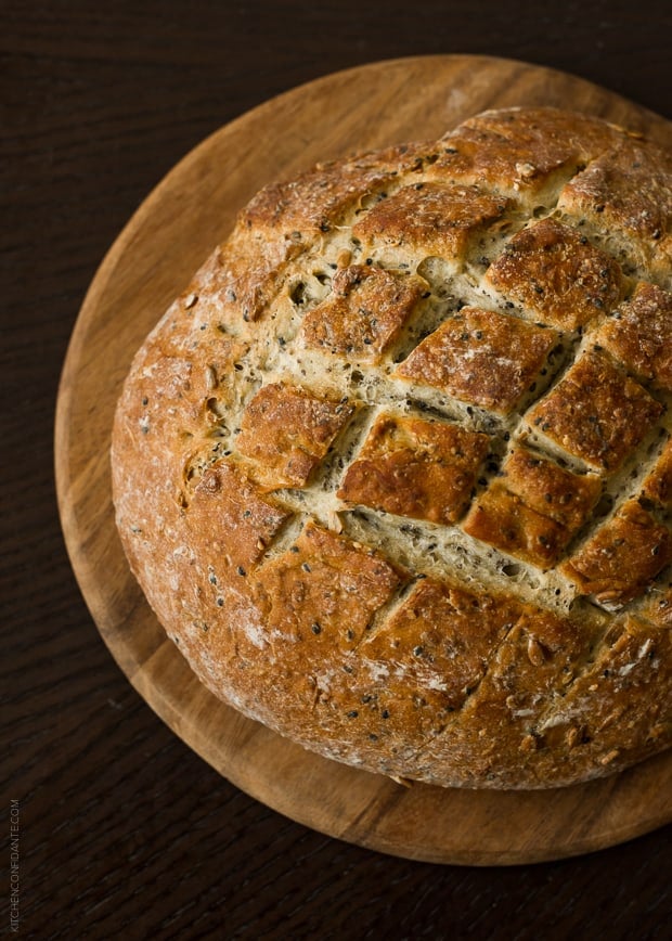 A loaf of golden brown seed bread.