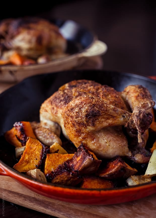 Roasted sweet potatoes and a Cornish hen in a skillet.