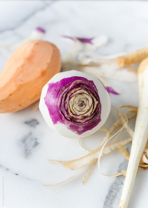 A peeled turnip, sweet potato, and parsnip.