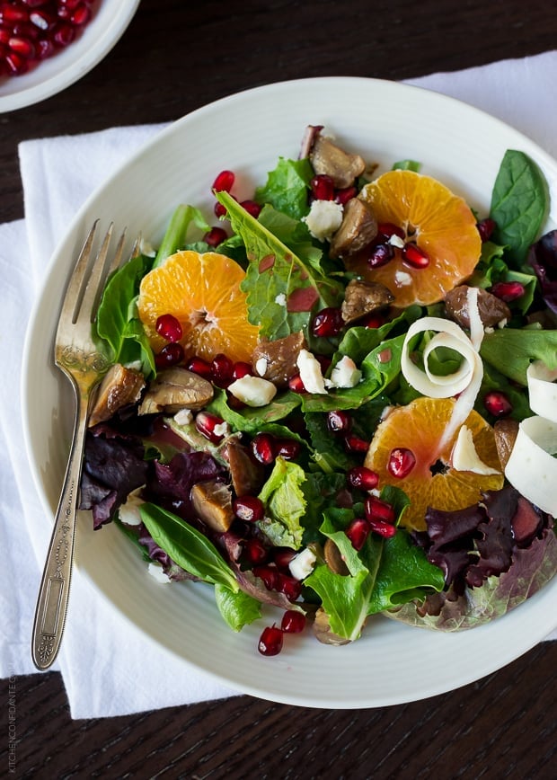 Chestnut Salad with Pomegranate Dressing sprinkled with roasted chestnuts, gorgonzola, citrus slices, and pomegranate arils.