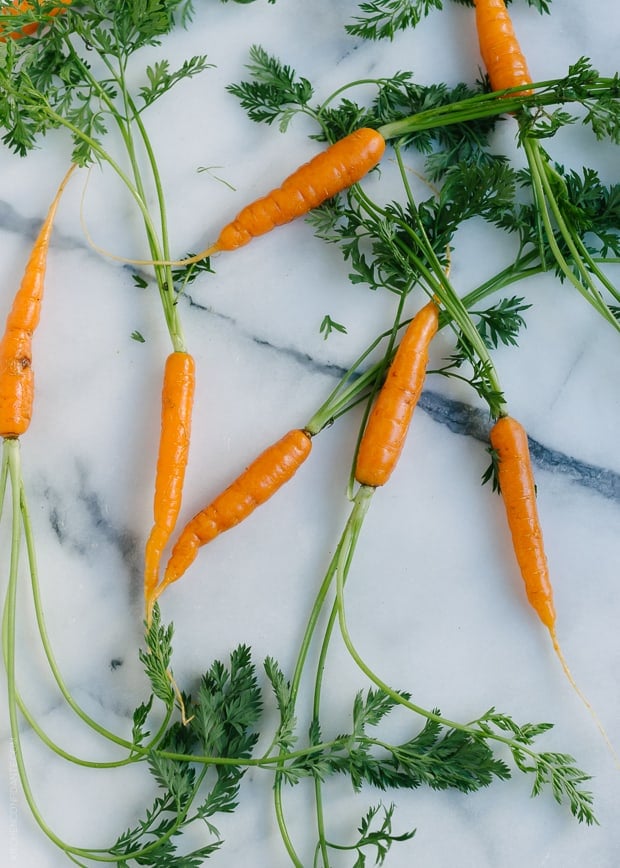 Fresh carrots on a marble surface.