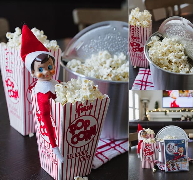 The Elf on a Shelf tucked into red and white containers of popcorn.