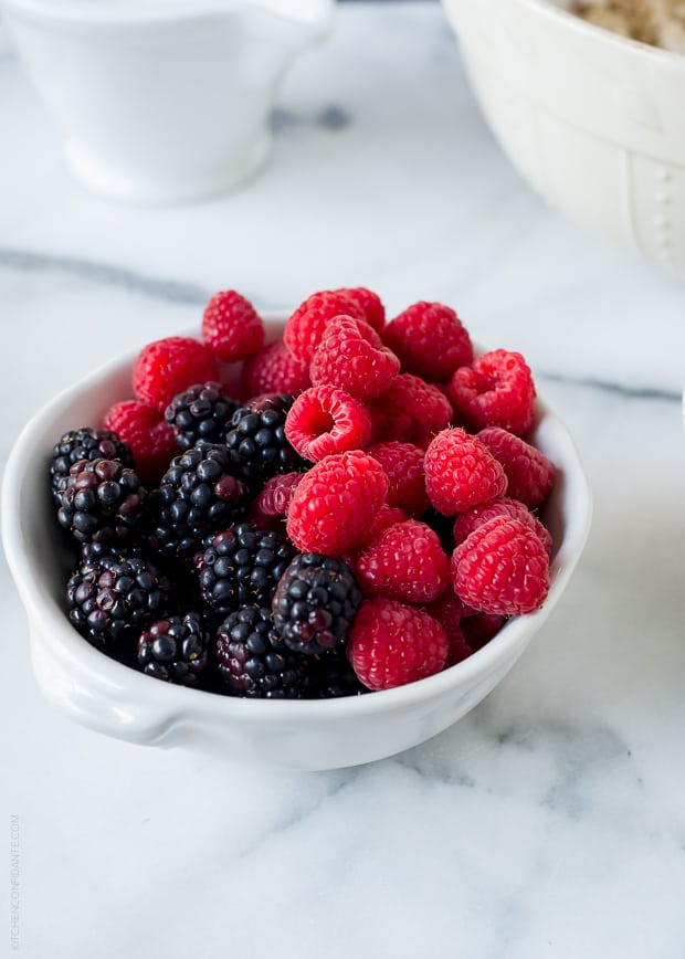 A bowl filled with fresh blackberries and raspberries.