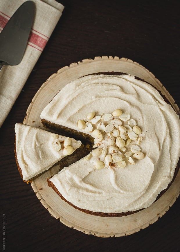 Pumpkin Marcona Almond Cake topped with frosting and more almonds.