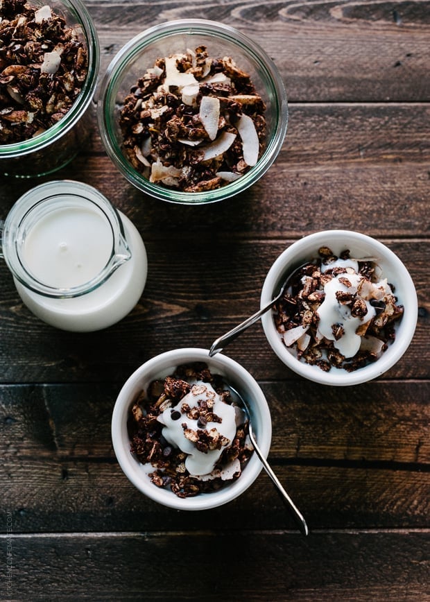 Small white bowls of Mocha Coconut Granola on a wooden surface.