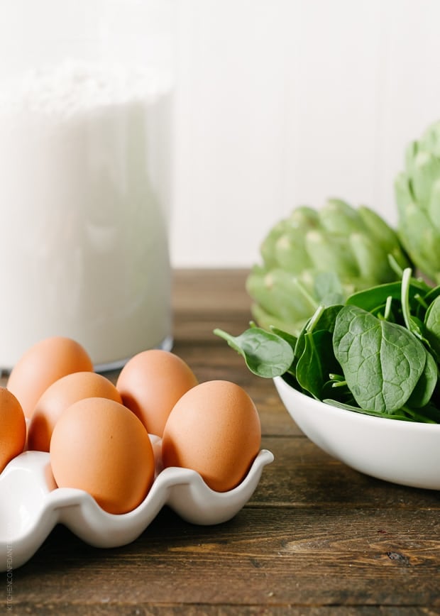 Fresh eggs and a bowl of fresh spinach.