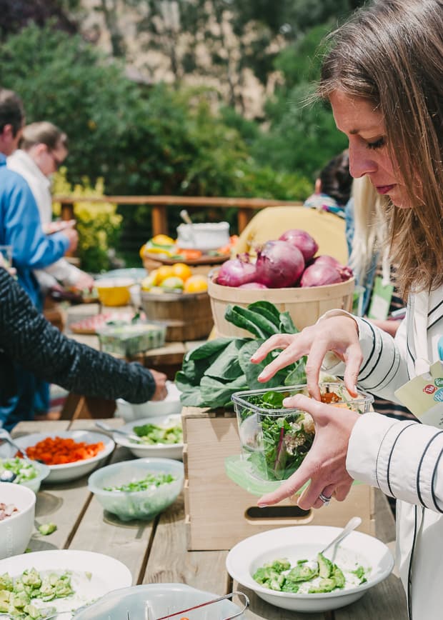 A woman making a salad.