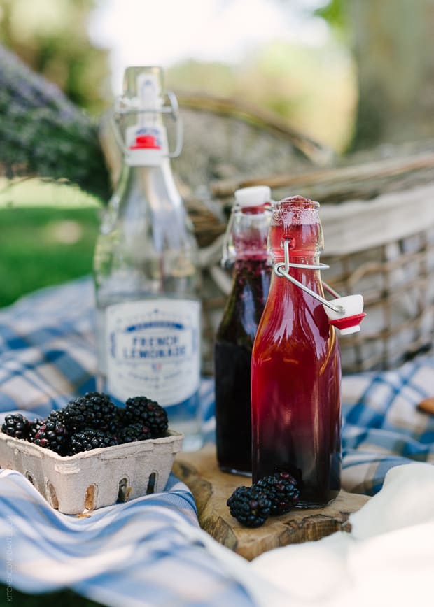 Blackberry Shrub Lemonade in glass bottles.