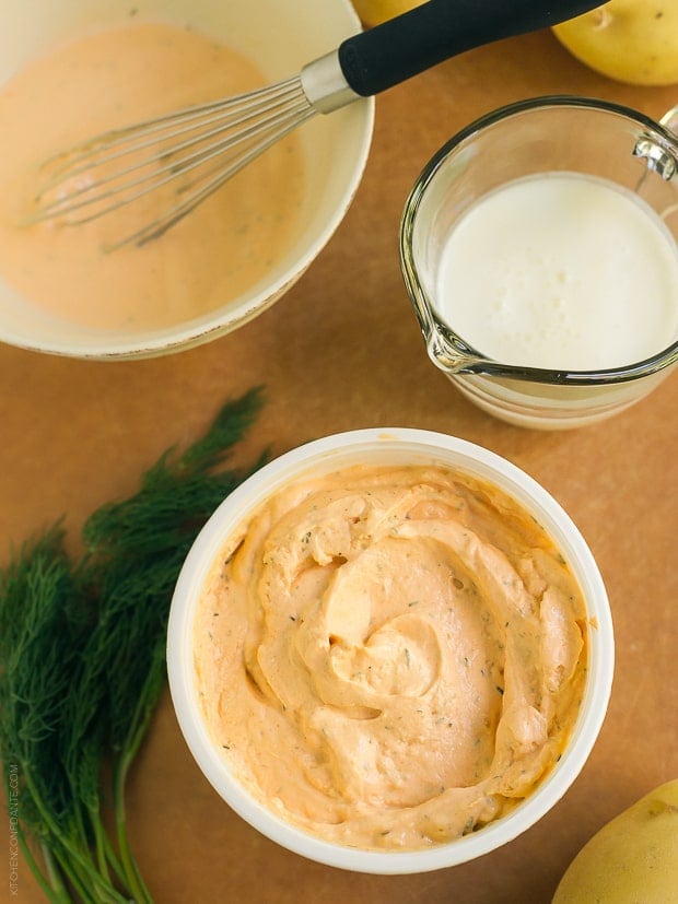 A container Buffalo Ranch dip and a measuring cup filled with buttermilk.