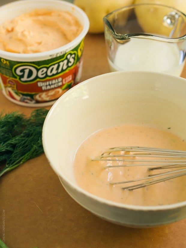 Dean's Dairy Dip Buffalo Ranch Dip in a white bowl with a whisk.