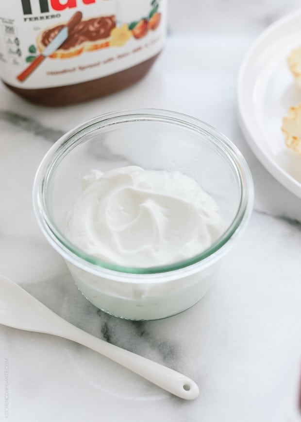 A glass bowl filled with Greek yogurt.