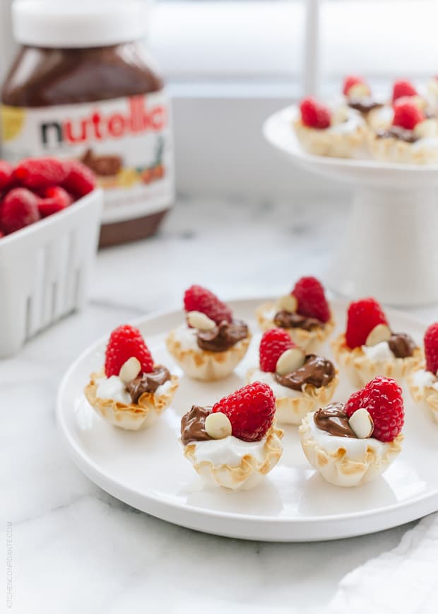 Nutella Greek Yogurt Phyllo Cups topped with a raspberry and a slivered almond.